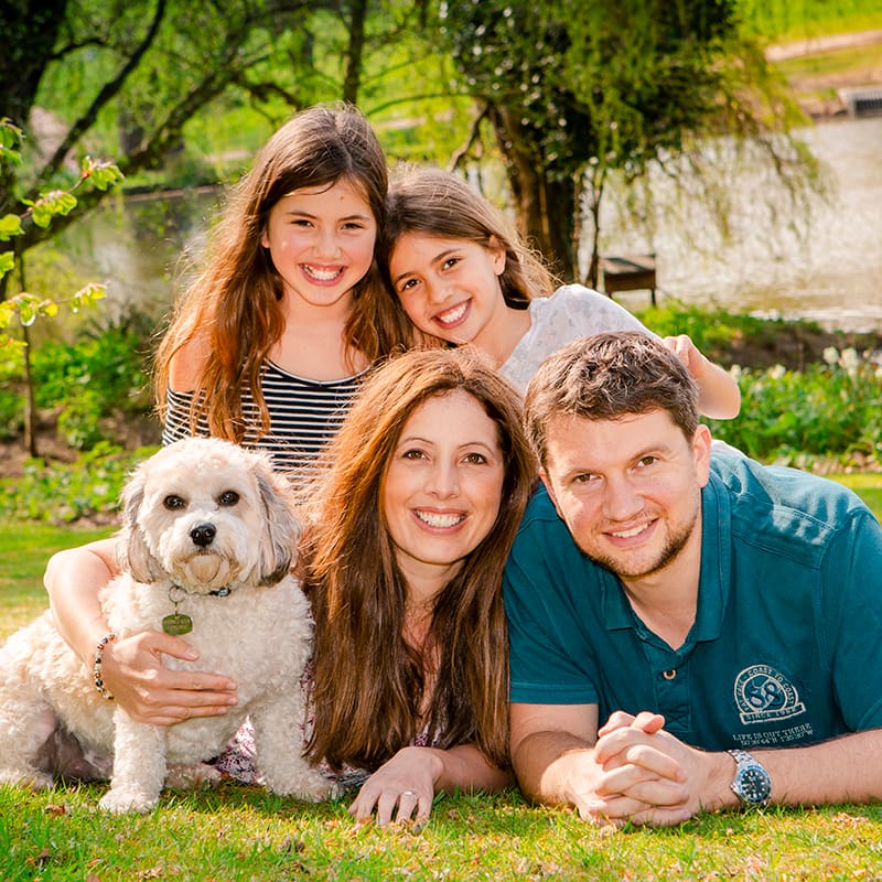 Family photo outside with family of four with dog.