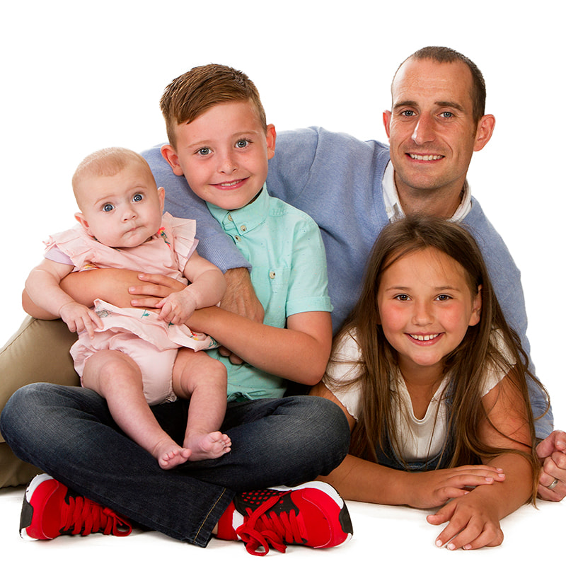 Studio photo shoot of dad with his three children