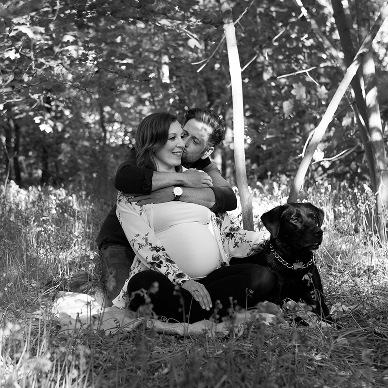 Maternity shoot in a wood in Colchester, couple with their dog.